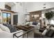 Comfortable living room featuring high ceilings, a stone fireplace, and stylish decor at 27914 N 100Th Pl, Scottsdale, AZ 85262