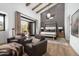 Spacious main bedroom with beamed ceilings, seating area, and a large opening to the terrace at 27914 N 100Th Pl, Scottsdale, AZ 85262