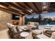 Inviting outdoor living space features a fireplace, comfortable seating, and a relaxing pool view at 27914 N 100Th Pl, Scottsdale, AZ 85262
