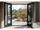 View from the bedroom onto the patio, with desert landscaping and lounge chairs at 27914 N 100Th Pl, Scottsdale, AZ 85262