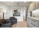 Bright sitting area with wood floors, gray chairs, marble countertop, and custom cabinetry with brass fixtures at 27914 N 100Th Pl, Scottsdale, AZ 85262