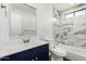 Modern bathroom featuring marble tile, stylish vanity, sink, and a shower-tub combination at 2818 E Villa Rita Dr, Phoenix, AZ 85032