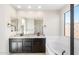 Stylish bathroom showcases dual sinks, granite counters, tub, and a shower with a glass enclosure at 31672 N 135Th Ln, Peoria, AZ 85383