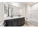 Lovely bathroom showcasing dual sinks, granite counters, and a shower and tub combo at 31672 N 135Th Ln, Peoria, AZ 85383