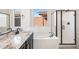 Modern bathroom featuring a soaking tub, shower and granite counters at 31672 N 135Th Ln, Peoria, AZ 85383