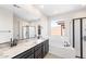 Elegant bathroom features a dual sink vanity, a soaking tub, and a glass-enclosed shower at 31672 N 135Th Ln, Peoria, AZ 85383