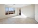 Well-lit bedroom featuring tile floors, a large window, and a bathroom entryway at 31672 N 135Th Ln, Peoria, AZ 85383