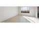 Bright bedroom with a large window showcasing neighborhood views at 31672 N 135Th Ln, Peoria, AZ 85383