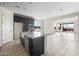 Open kitchen featuring a large island, stone countertops, stainless steel appliances, and tile flooring at 31672 N 135Th Ln, Peoria, AZ 85383