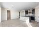 Bright kitchen with a central island, and modern black cabinetry at 31672 N 135Th Ln, Peoria, AZ 85383