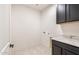 Well-equipped laundry room with granite countertops and ample storage space at 31672 N 135Th Ln, Peoria, AZ 85383