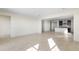 Open-concept living room and kitchen with sleek tile flooring and abundant natural light at 31672 N 135Th Ln, Peoria, AZ 85383