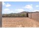 Large backyard showcasing the dirt and fence with mountain views in the background at 32076 N 136Th Ave, Peoria, AZ 85383
