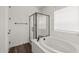 A well-lit bathroom showcases a shower with black trim, a soaking tub, and a window at 32076 N 136Th Ave, Peoria, AZ 85383