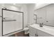 Bright bathroom featuring white vanity, modern black fixtures, and a glass-enclosed shower at 32076 N 136Th Ave, Peoria, AZ 85383