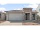 Charming single-story home featuring a stone facade, desert landscaping, and a spacious two-car garage at 32076 N 136Th Ave, Peoria, AZ 85383