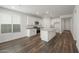 Bright kitchen with white cabinets, granite countertops, stainless steel appliances, and hardwood floors at 32076 N 136Th Ave, Peoria, AZ 85383