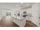 Open concept kitchen with island, stainless steel appliances, granite countertops, and hardwood floors at 32076 N 136Th Ave, Peoria, AZ 85383
