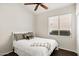 Cozy bedroom featuring a ceiling fan, window with blinds, and neutral decor at 3431 S Felix Way, Chandler, AZ 85248