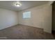 Cozy bedroom featuring neutral carpet, window, and a closet door at 3613 W El Caminito Dr, Phoenix, AZ 85051