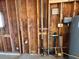 Garage wall shows exposed studs and utilities, illustrating the home's functional systems at 3613 W El Caminito Dr, Phoenix, AZ 85051