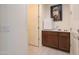 Hallway nook includes brown cabinets with white marble countertops and mini refrigerator at 4576 W Agave W Ave, Eloy, AZ 85131