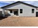 View of the home's backyard, featuring a covered patio area and a blank canvas for landscaping at 47747 W Kenner Dr, Maricopa, AZ 85139