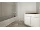 Clean, bright bathroom featuring a modern shower/tub and vanity with storage space at 47747 W Kenner Dr, Maricopa, AZ 85139