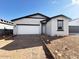 Charming single-story home featuring a two-car garage and a low-maintenance front yard at 47747 W Kenner Dr, Maricopa, AZ 85139