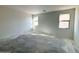 Spacious living room featuring multiple windows for ample natural light and an open layout at 47747 W Kenner Dr, Maricopa, AZ 85139