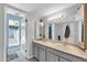 Bathroom featuring a double vanity, large mirror, and neutral color scheme at 62 W Secretariat Dr, Tempe, AZ 85284