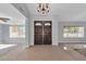 Inviting foyer featuring tiled flooring, light gray walls, and decorative double front doors at 62 W Secretariat Dr, Tempe, AZ 85284
