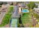Expansive property featuring a pool, sports court, lush lawns, and mature landscaping from an aerial perspective at 620 W Mclellan Blvd, Phoenix, AZ 85013