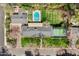 Aerial view of a property showcasing a pool, sports court, well-maintained lawns, and mature landscaping at 620 W Mclellan Blvd, Phoenix, AZ 85013