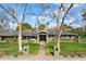 Charming single-story home with lush landscaping, mature trees, and a brick pathway leading to the front door at 620 W Mclellan Blvd, Phoenix, AZ 85013