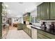 Bright kitchen with modern appliances, a farmhouse sink, dark countertops and sleek tiled backsplash at 620 W Mclellan Blvd, Phoenix, AZ 85013