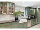 Bright kitchen features a farmhouse sink, dark countertops, sleek backsplash, and stainless steel appliances at 620 W Mclellan Blvd, Phoenix, AZ 85013