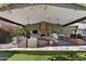 Covered patio featuring an outdoor kitchen, dining area, living space, and brick fireplace at 620 W Mclellan Blvd, Phoenix, AZ 85013