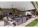 Covered patio featuring an outdoor kitchen, dining area, living space, and brick fireplace at 620 W Mclellan Blvd, Phoenix, AZ 85013