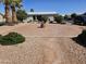 Spacious brick patio features desert landscaping and a brick fire pit, perfect for outdoor entertaining at 650 N Hawes Rd # 4716, Mesa, AZ 85207