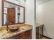 Bathroom featuring granite counter tops, custom wood cabinetry, and a vessel sink at 7111 E Sienna Bouquet Pl, Scottsdale, AZ 85266