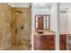 Bathroom featuring a walk-in shower, granite counter tops, and custom wood cabinetry at 7111 E Sienna Bouquet Pl, Scottsdale, AZ 85266