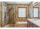 Elegant bathroom featuring a soaking tub and marble accents, illuminated by stylish lighting at 7111 E Sienna Bouquet Pl, Scottsdale, AZ 85266