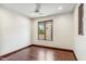 Bedroom with wood floors, ceiling fan and view to private patio at 7111 E Sienna Bouquet Pl, Scottsdale, AZ 85266