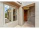 Inviting entryway with a solid wood door, and a glimpse of the chandelier inside at 7111 E Sienna Bouquet Pl, Scottsdale, AZ 85266