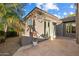 A cozy patio and landscaped exterior with stone flooring, accessed by glass doors at 7111 E Sienna Bouquet Pl, Scottsdale, AZ 85266