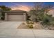 Charming home featuring a desert landscape and a two-car garage at 7111 E Sienna Bouquet Pl, Scottsdale, AZ 85266