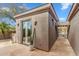 A private courtyard with desert landscaping and a covered walkway to the main house at 7111 E Sienna Bouquet Pl, Scottsdale, AZ 85266