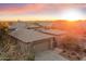 A captivating exterior shot of the home during a colorful sunset at 7111 E Sienna Bouquet Pl, Scottsdale, AZ 85266