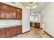 Hallway with travertine flooring, custom cabinets, and lighting at 7111 E Sienna Bouquet Pl, Scottsdale, AZ 85266